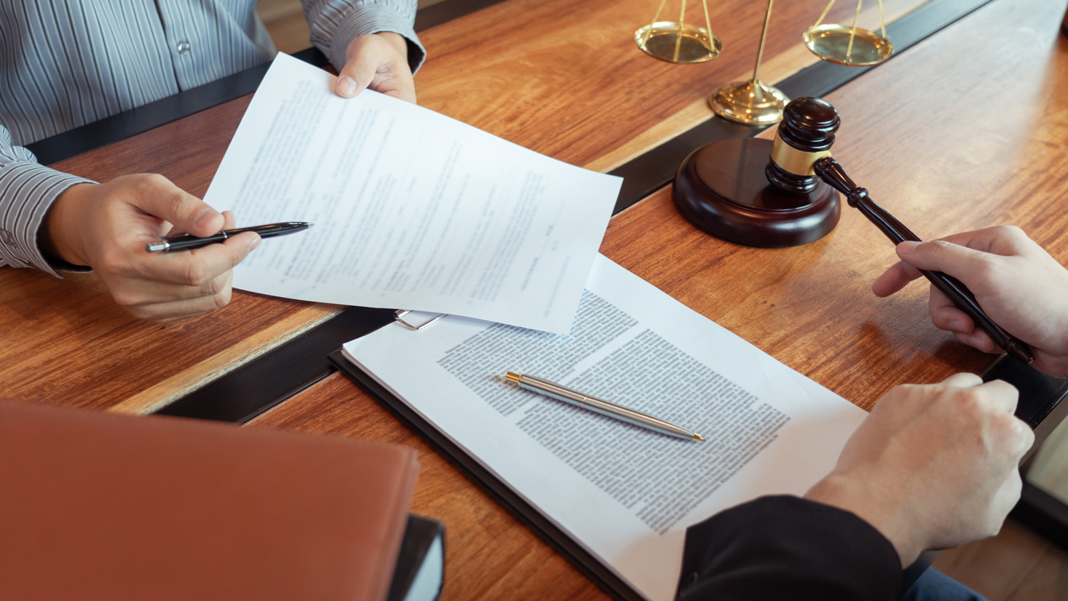 Picture of two people filling some documents 